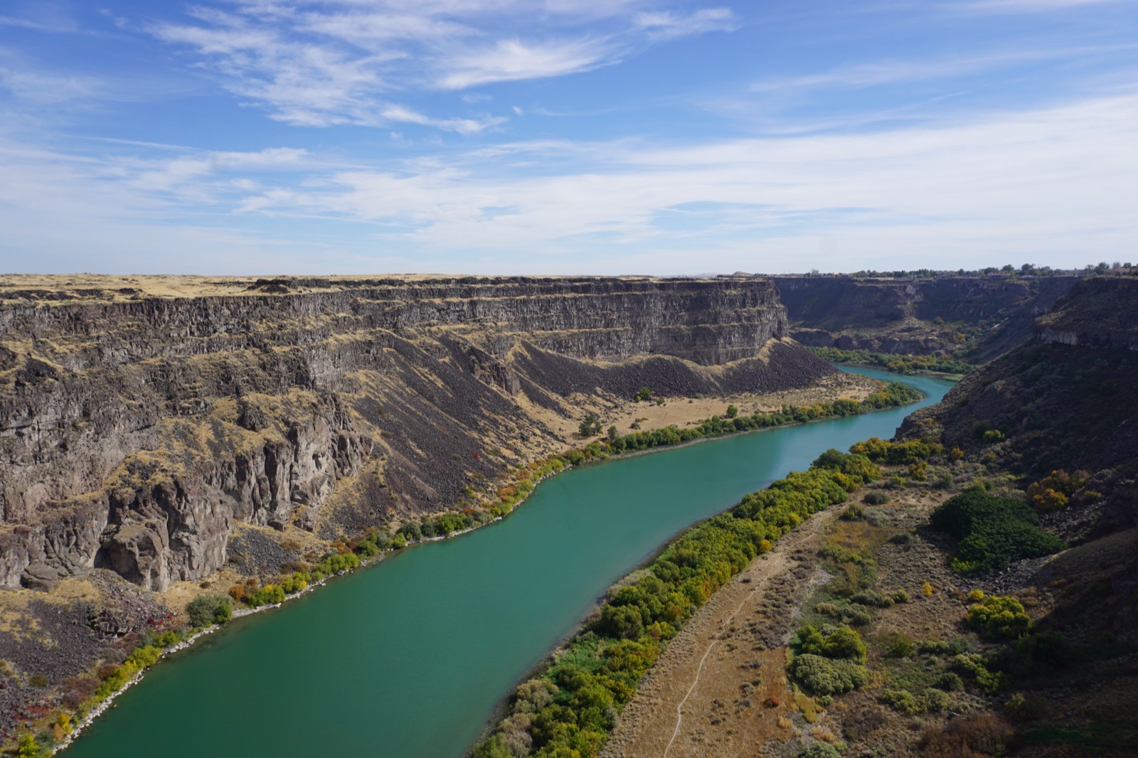Bluey-green river with canyon walls along the side.