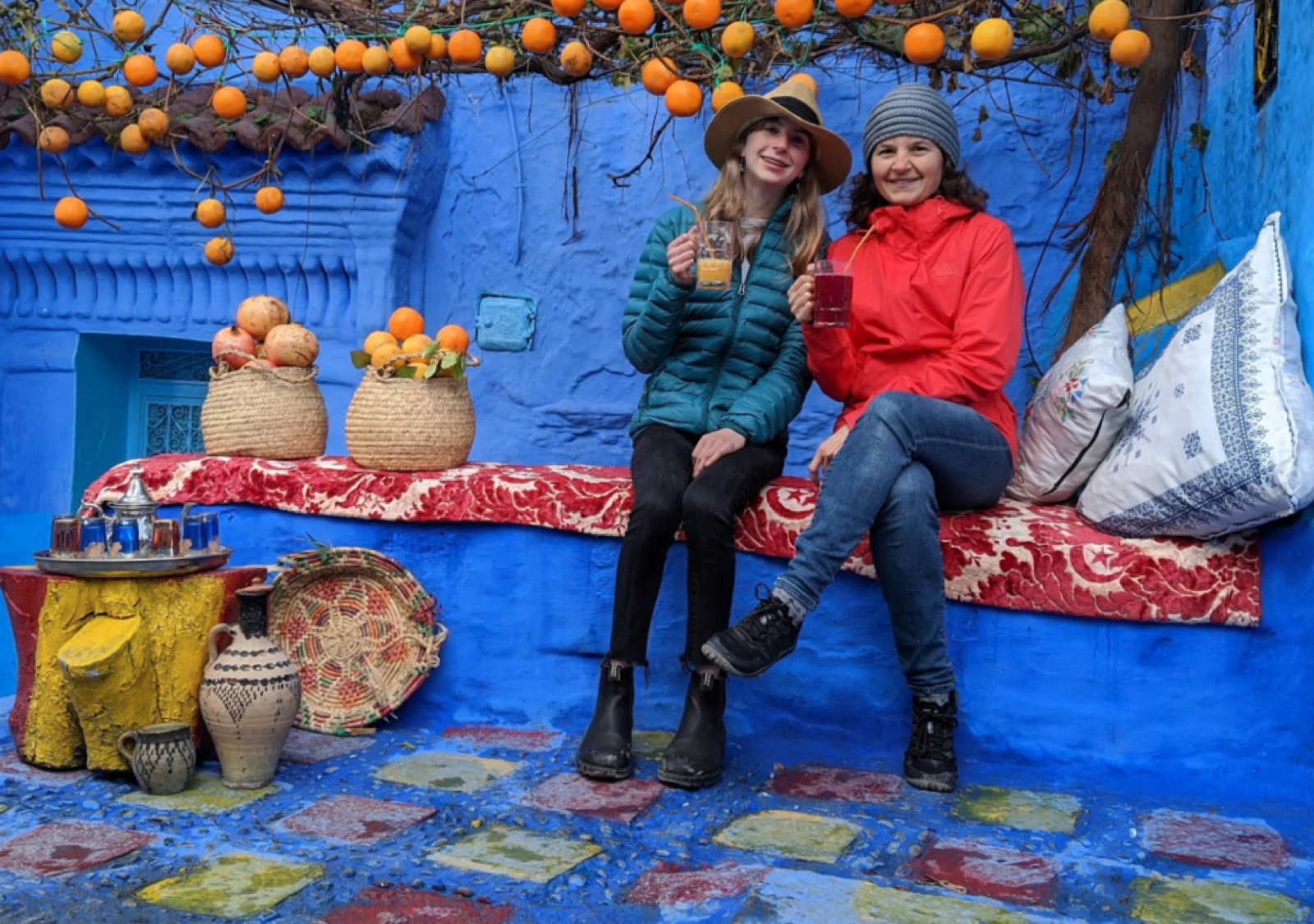 Two people sitting at Said's juice stand